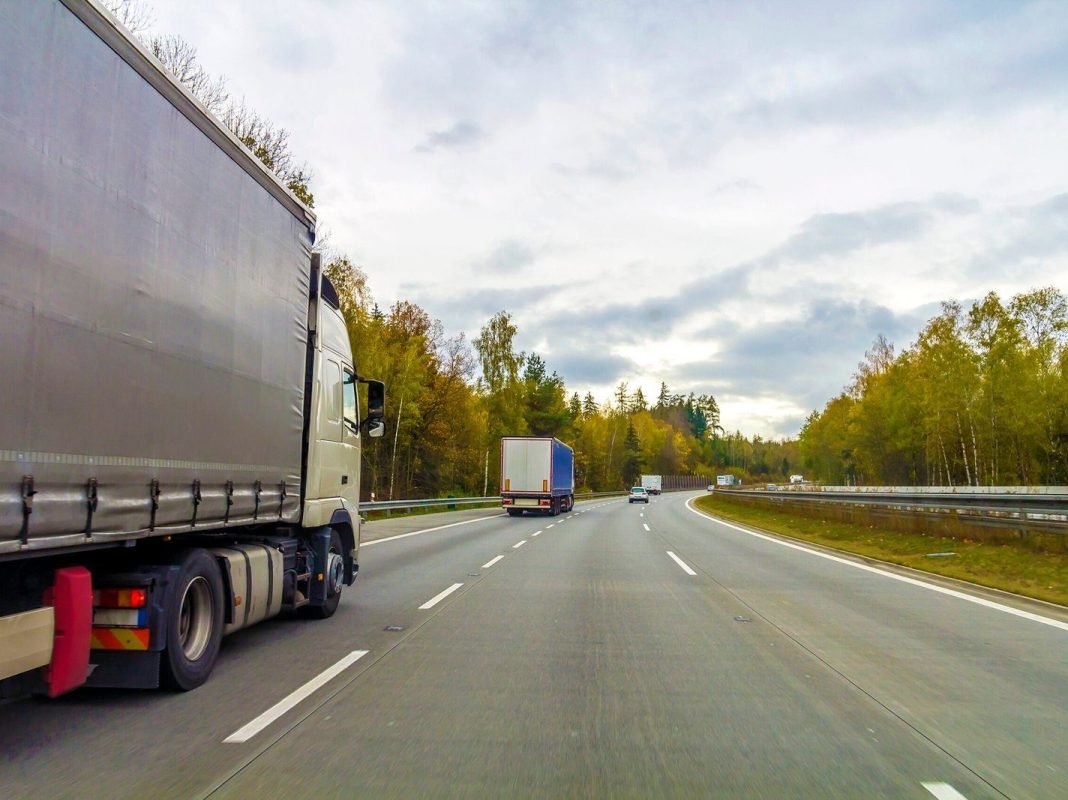 Truck on freeway road, cargo transportation concept